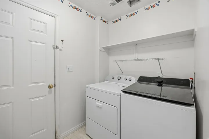 White paneled door, wall-mounted shelving, and appliances