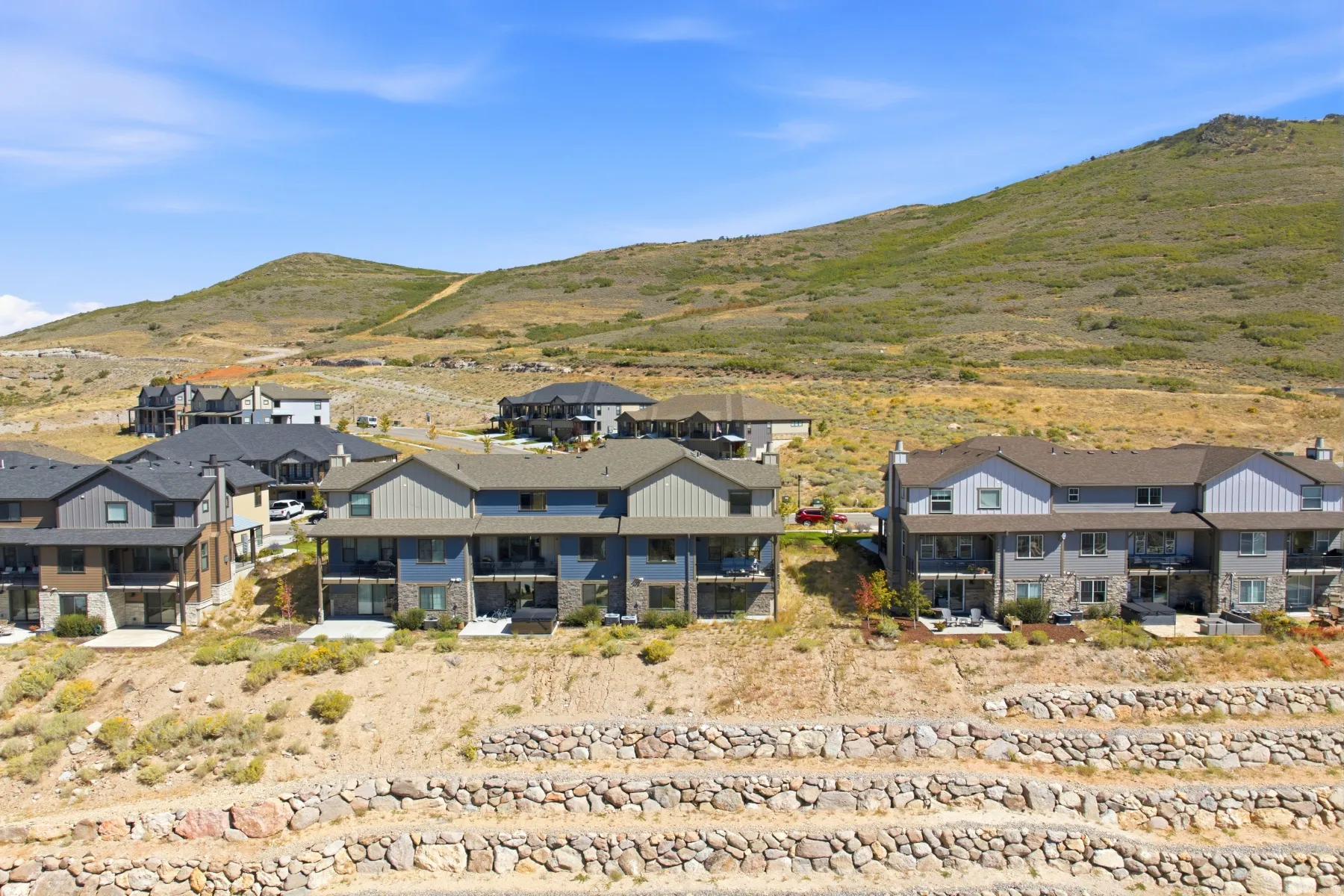 Terraced stone retaining walls complement the natural terrain