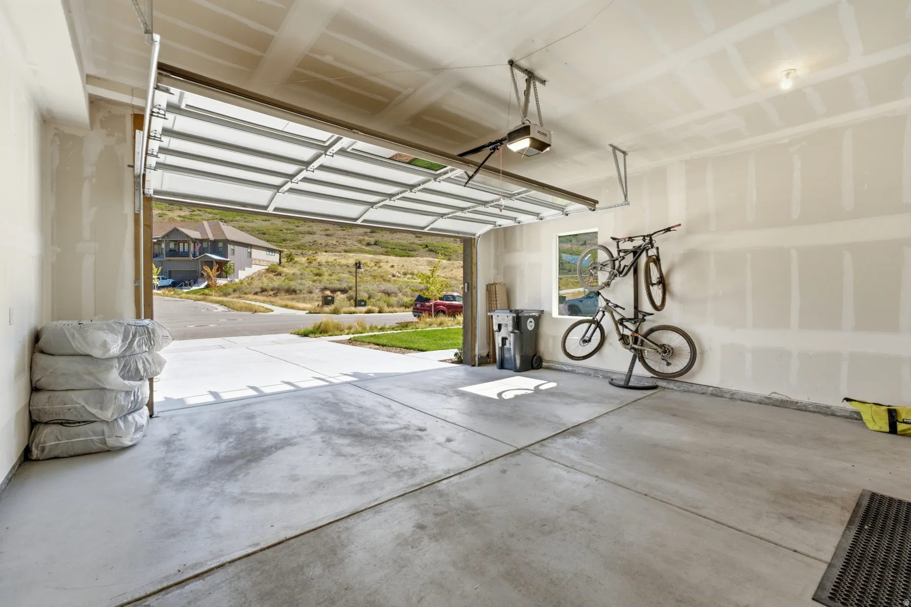 Concrete flooring, automatic garage door opener, interior window, ample wall space