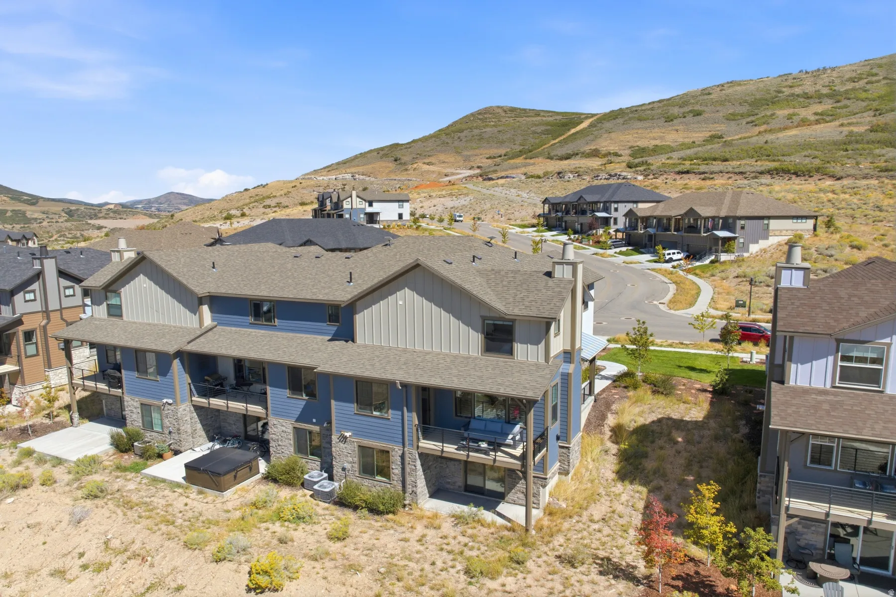 Townhome community with varied exterior finishes, stone accents, and private balconies