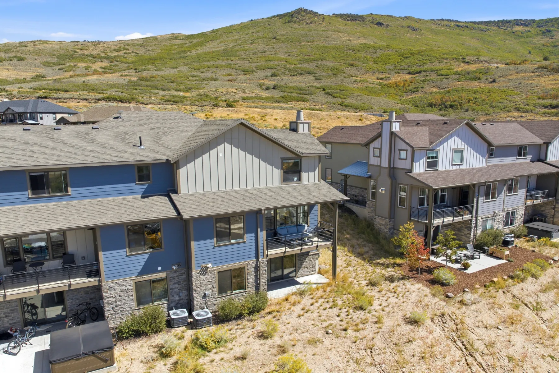 Multi-level exterior featuring stone veneer, horizontal siding, and vertical siding accents