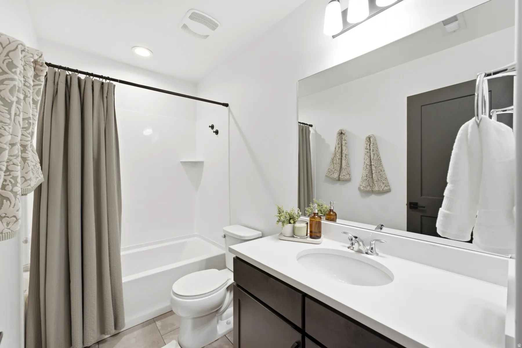 White tub/shower combination with matte black fixtures