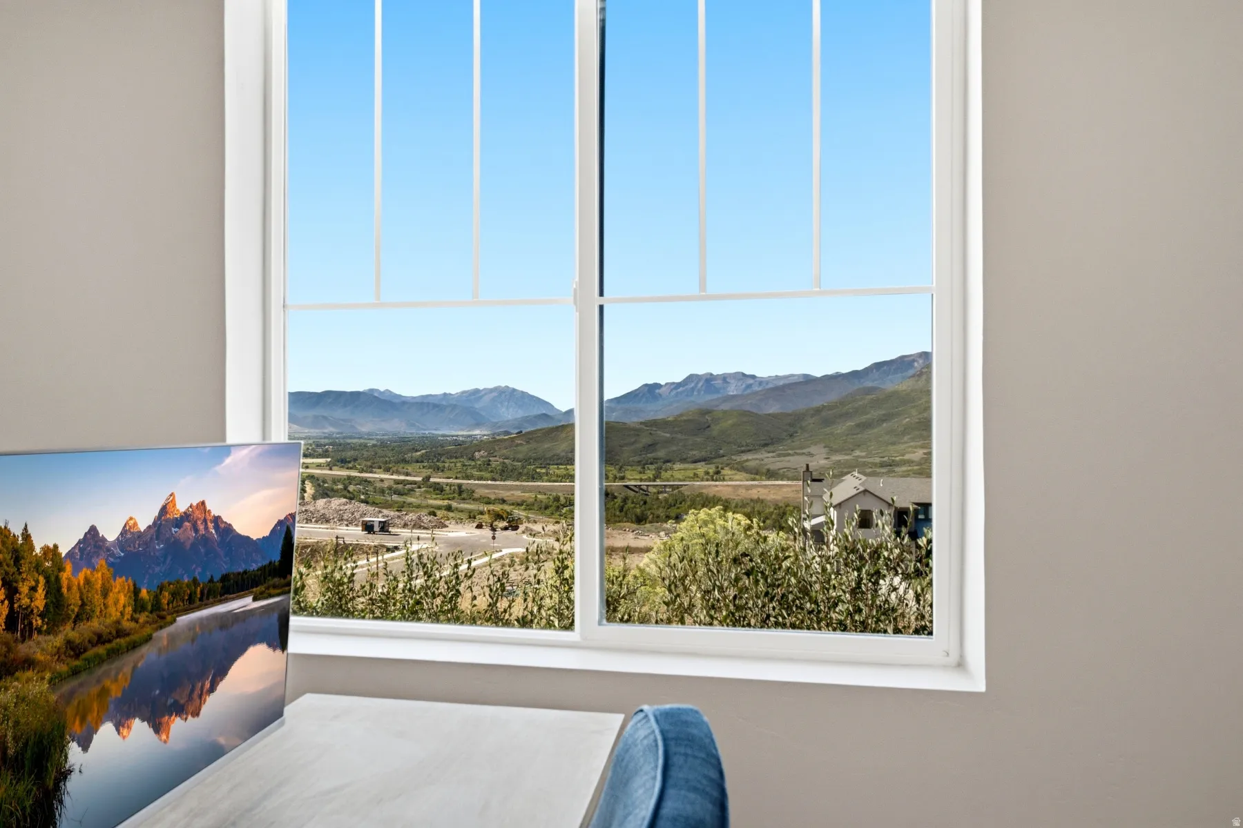 White-framed window offering expansive mountain scenery