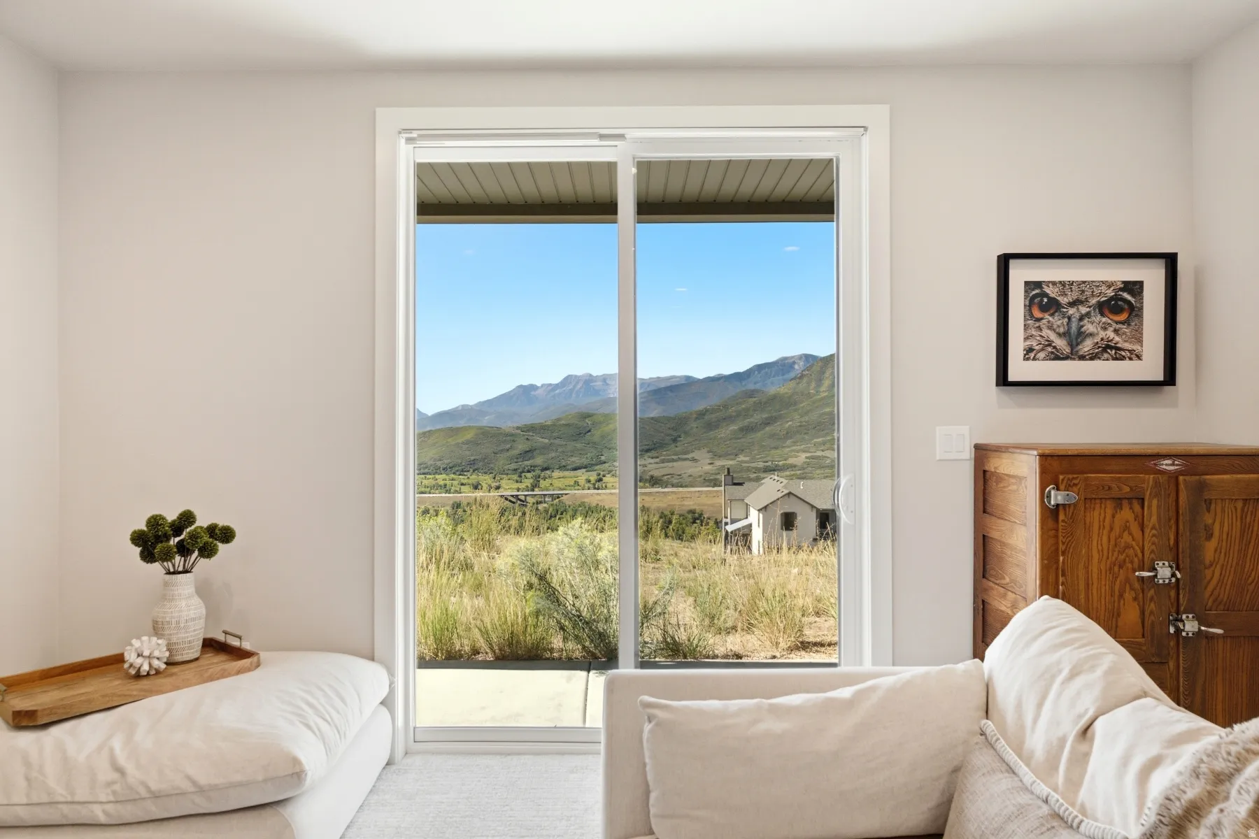 Sliding glass door leading to exterior, offering expansive mountain scenery