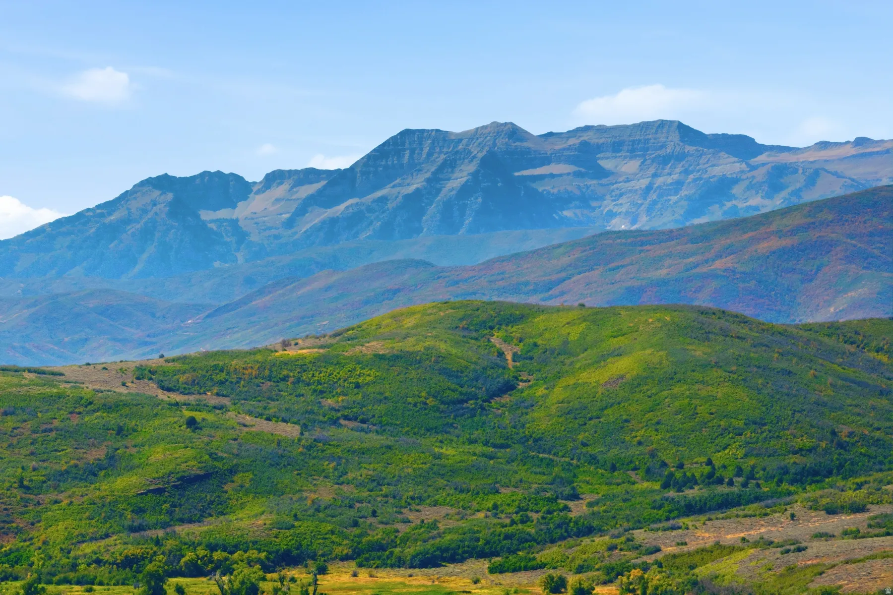 Expansive mountainous terrain with varied elevations and lush green foliage