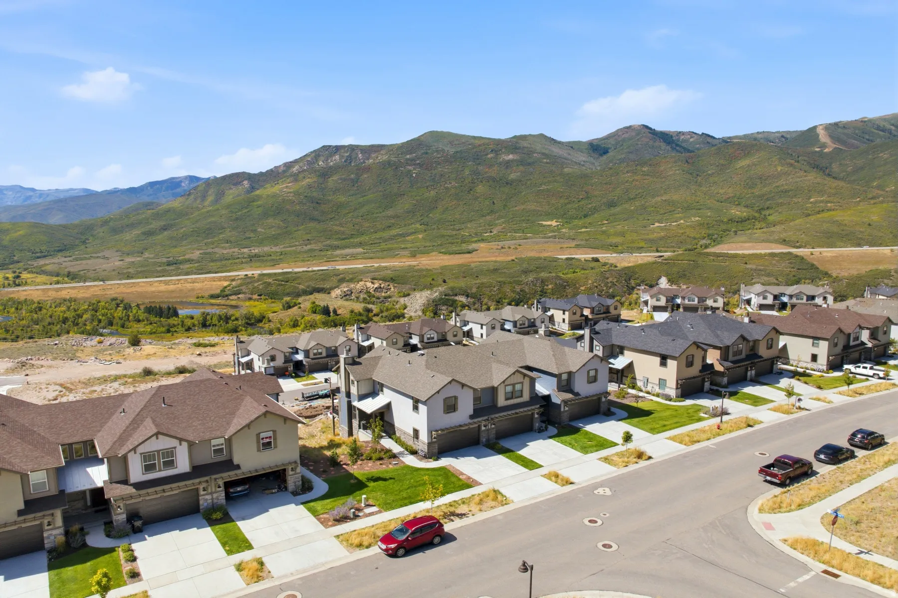 Mountainous terrain provides a natural backdrop for this residential area featuring paved streets and manicured lawns