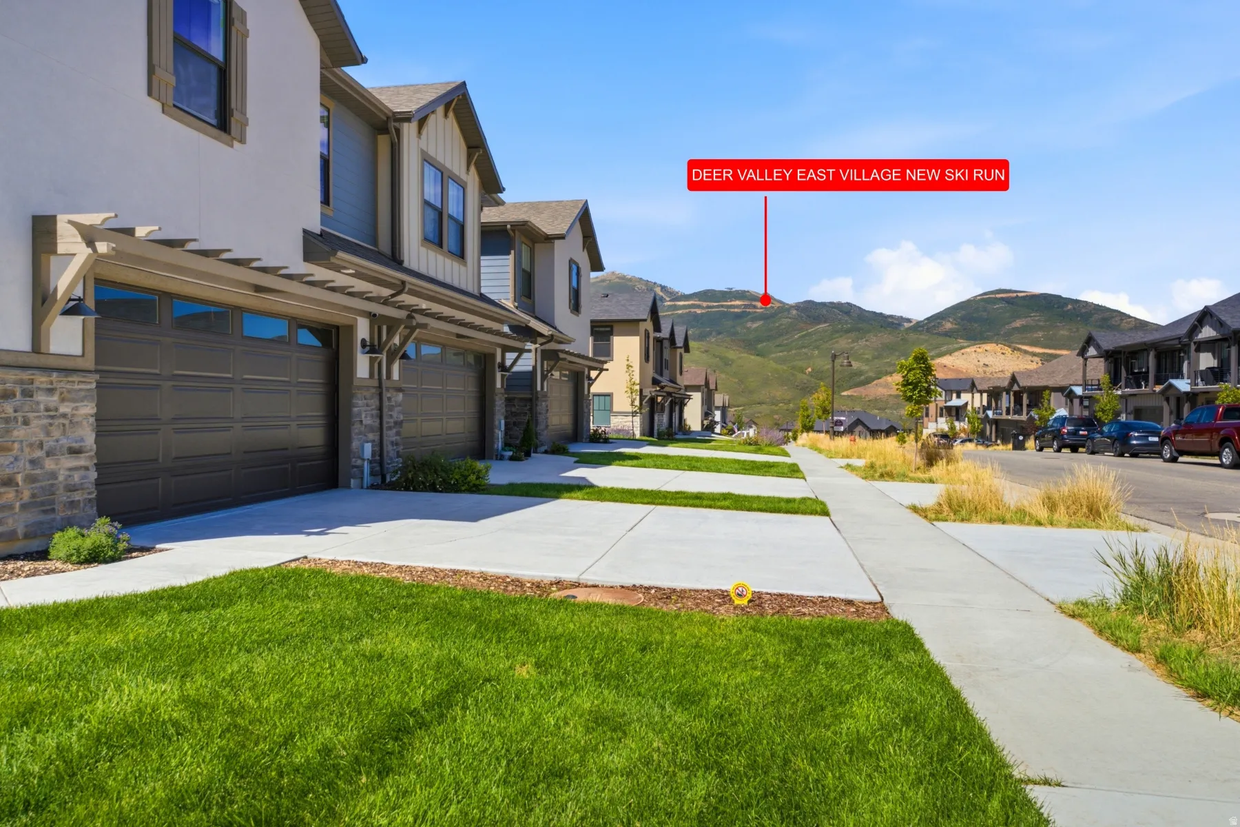 Modern townhome exterior with stone accents, horizontal siding, and a two-car garage