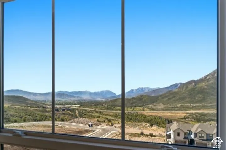 Expansive scenic view from primary bedroom featuring distant mountains and a broad valley