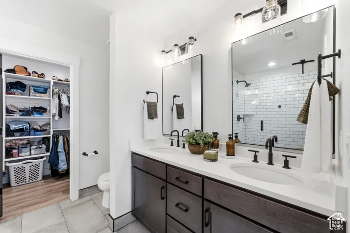 Dual vanity with white countertops and dark wood-finish cabinetry