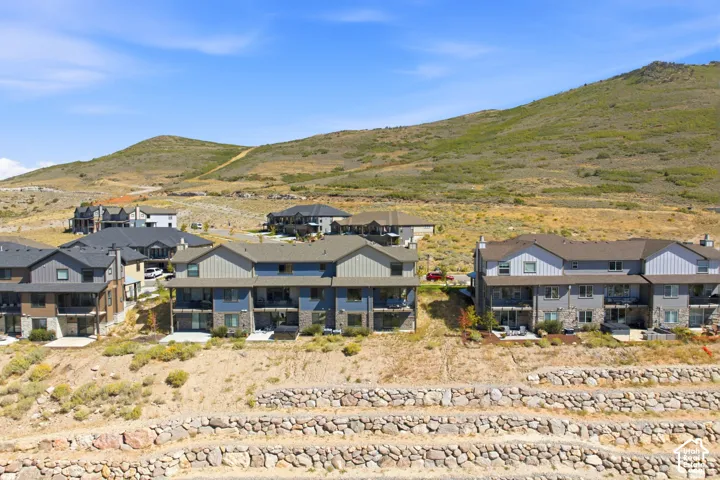 Terraced stone retaining walls complement the natural terrain
