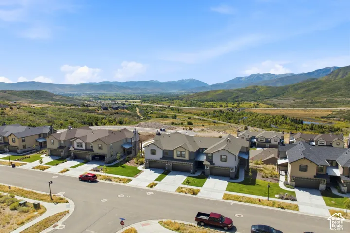 New construction homes with attached garages, manicured lawns, and paved driveways