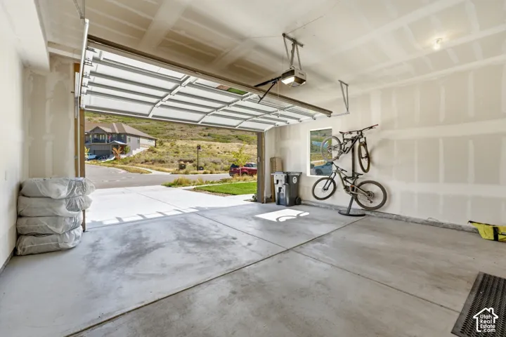 Concrete flooring, automatic garage door opener, interior window, ample wall space