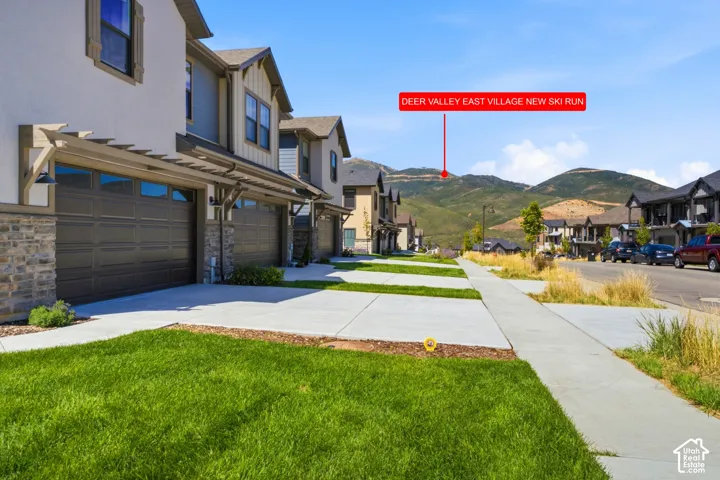 Modern townhome exterior with stone accents, horizontal siding, and a two-car garage