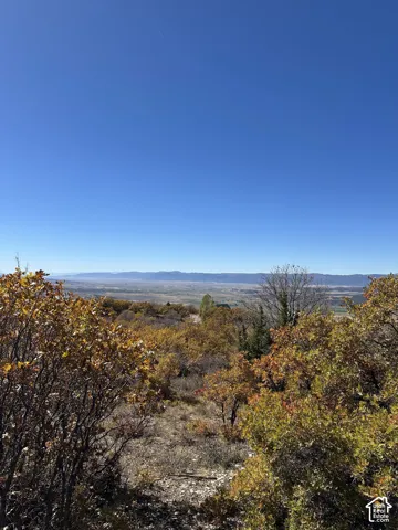 Expansive natural landscape featuring varied terrain and distant mountain ranges
