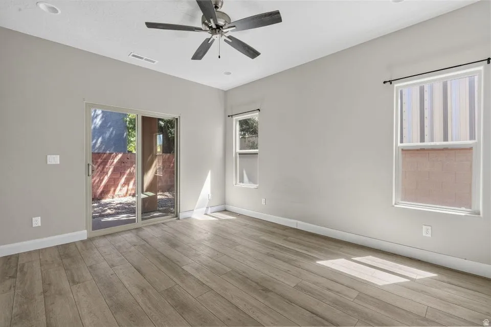 Wood-finish flooring, recessed lighting, and a ceiling fan with light fixture
