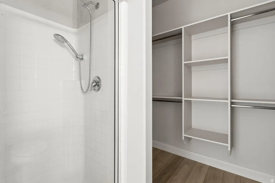 Walk-in shower with white subway tile surround and brushed nickel fixtures