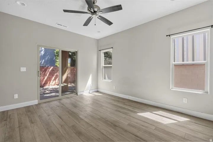 Wood-finish flooring, recessed lighting, and a ceiling fan with light fixture