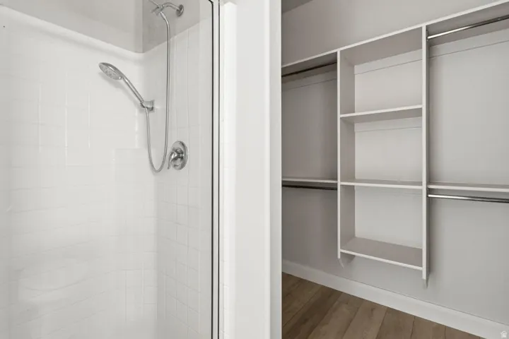 Walk-in shower with white subway tile surround and brushed nickel fixtures
