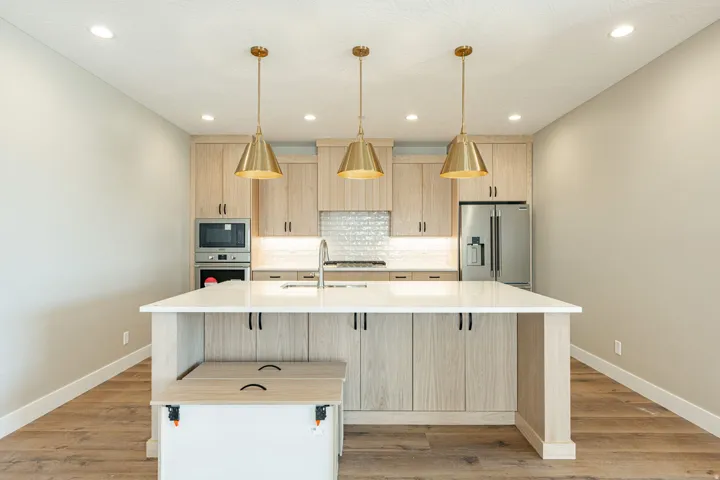 Kitchen featuring wood-finish flooring, recessed lighting, and a center island with pendant lights