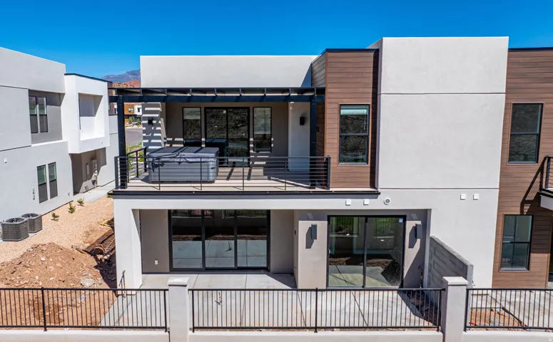 Multi-level exterior with stucco and wood-finish siding