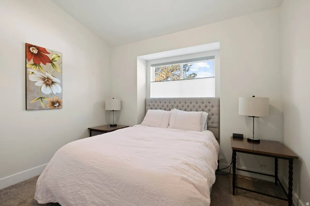 Recessed window with privacy shades and a light-colored headboard