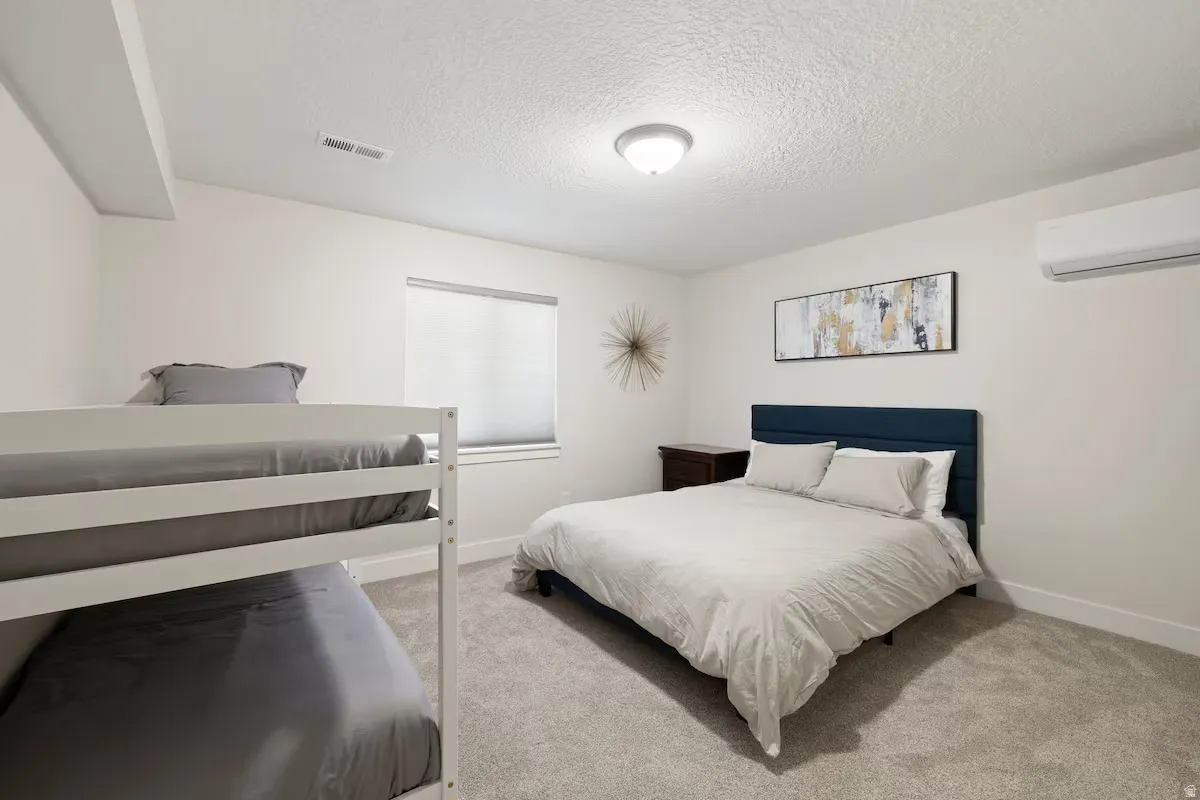Neutral wall finishes, recessed lighting, and a window with blinds
