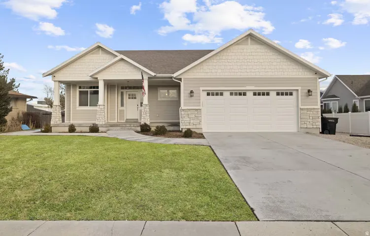 Exterior featuring horizontal siding, decorative shake siding, stone accents, and a covered entry