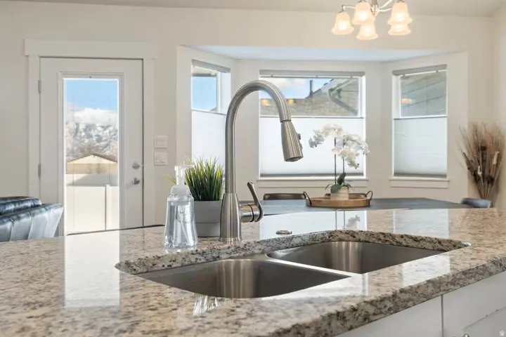 Granite-style countertop with double basin sink and gooseneck faucet