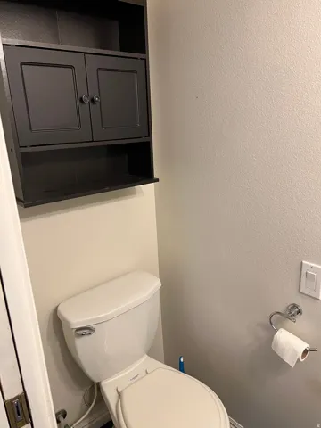 Built-in wall-mounted cabinetry with dark finish and open shelving