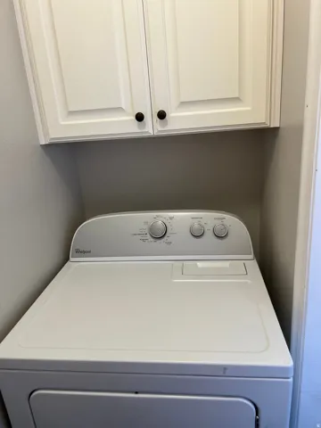 White upper cabinetry with dark round hardware