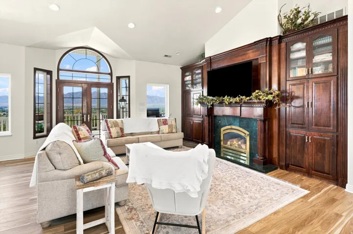 Wood-finish flooring throughout, featuring a vaulted ceiling and recessed lighting
