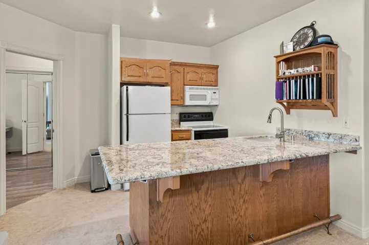 Full-size refrigerator, built-in microwave, and electric range