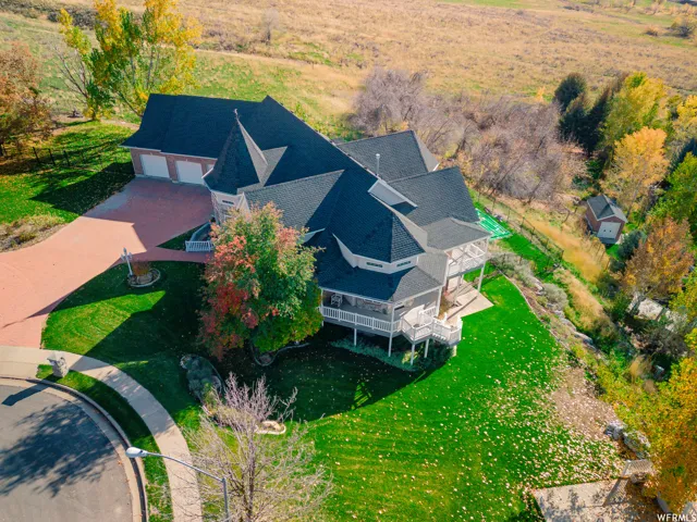 Expansive property featuring a multi-level structure with turret architectural elements and a dark roof