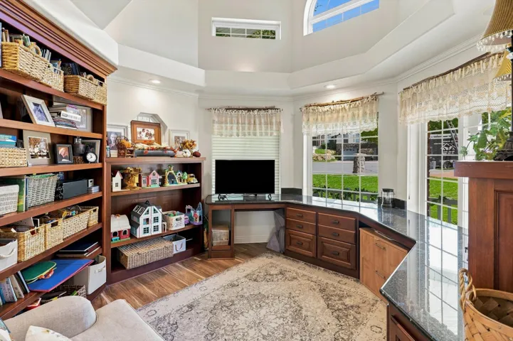 Built-in cabinetry with dark wood finish, dark countertops, and integrated shelving
