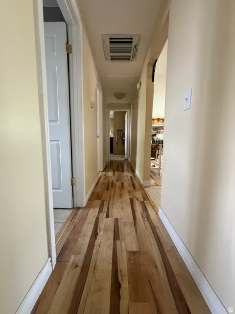 Wood-finish flooring extending through the hallway