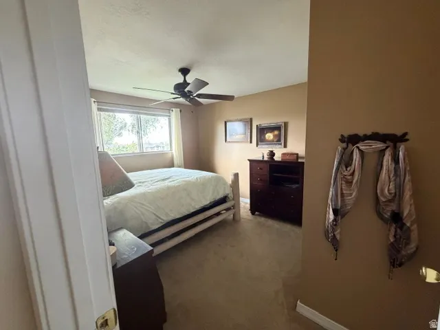 Carpeted flooring, recessed window, and ceiling fan