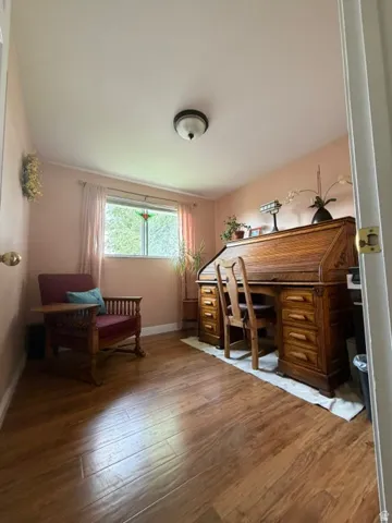 Wood-finish flooring with a flush-mount ceiling light fixture