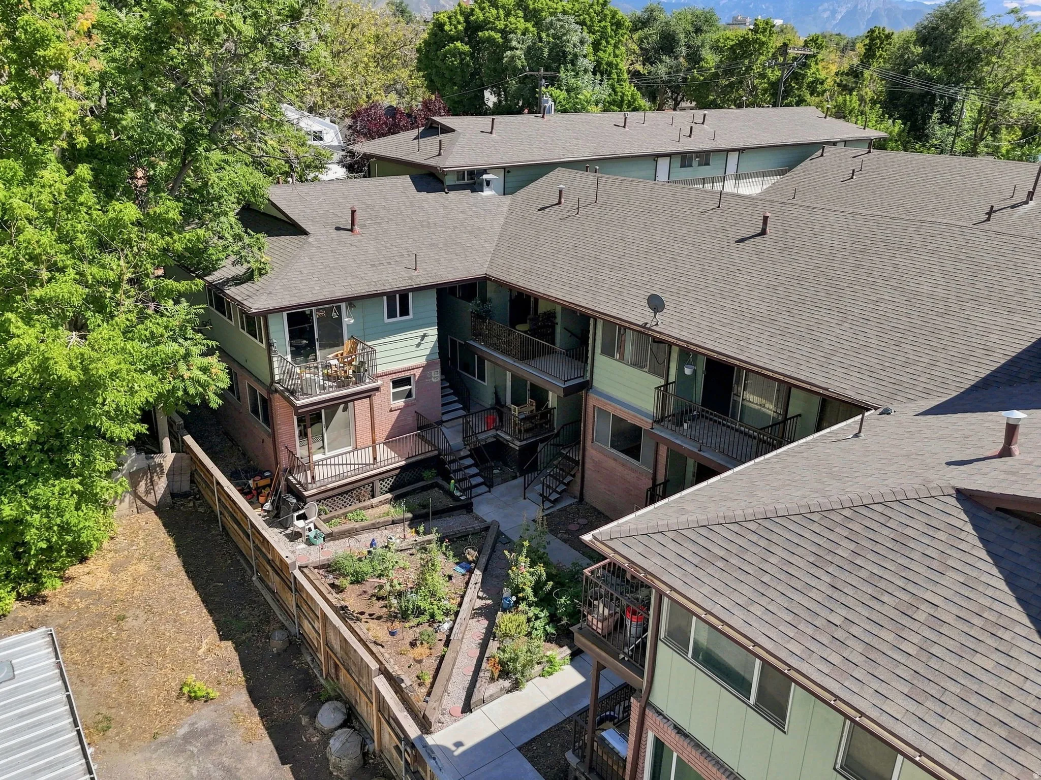 Multi-unit property featuring a U-shaped configuration with multiple balconies