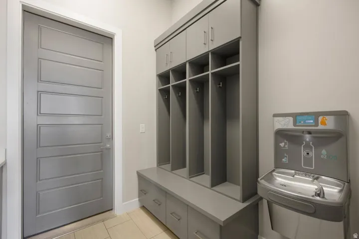 Built-in gray cabinetry with open cubbies, lower drawers, and upper storage