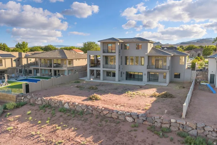 Contemporary residence featuring multiple balconies and expansive windows