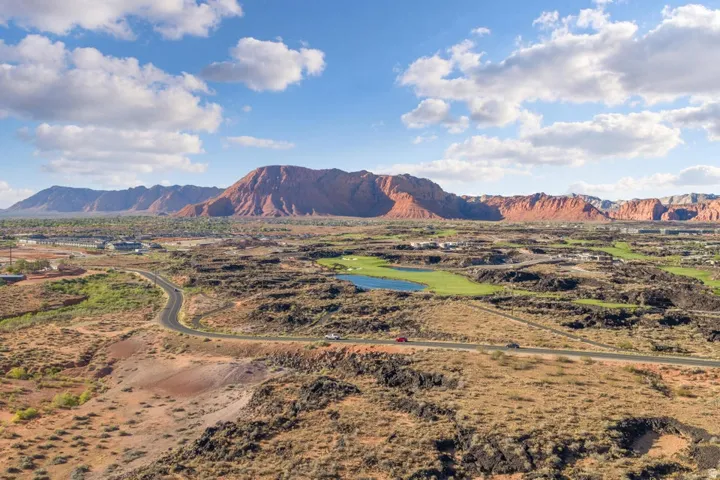 Expansive desert landscape with distant red rock formations