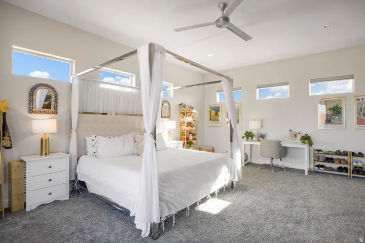 Vaulted ceilings, multiple transom windows, and a ceiling fan