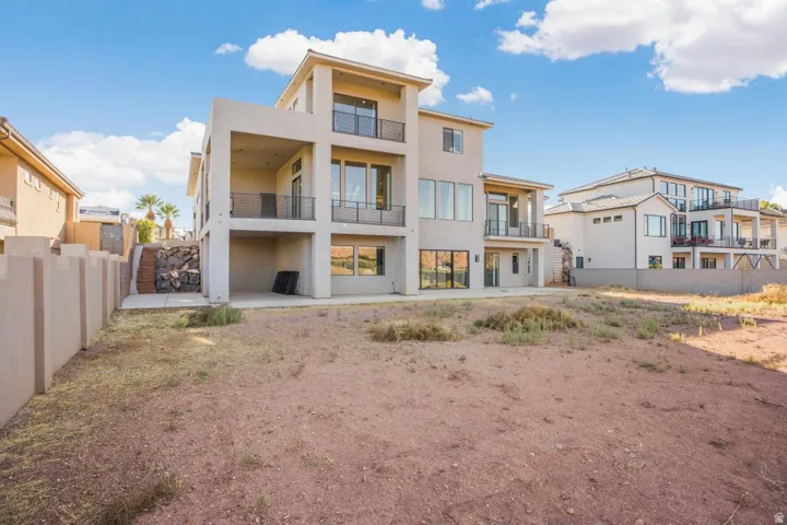 Contemporary exterior with multiple balconies, expansive windows, and a multi-level design