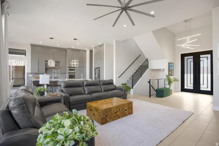 Vaulted ceiling with a contemporary ceiling fan and pendant lighting