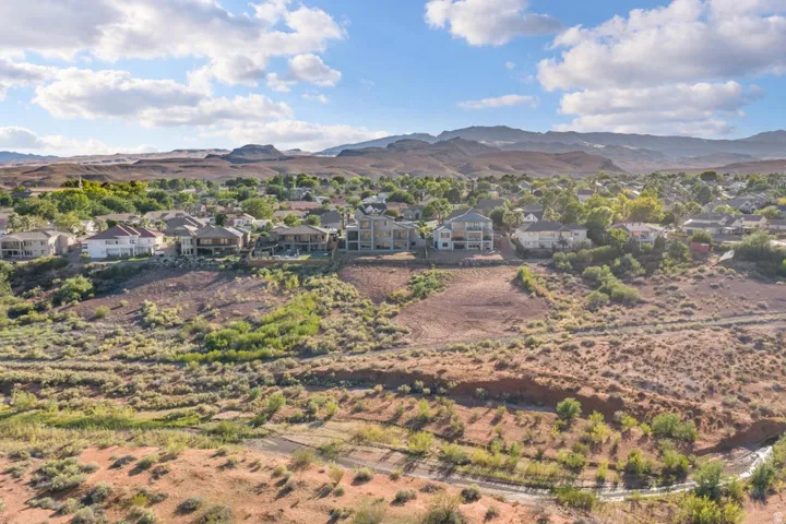 Residential area with varied architecture, established landscaping, and distant mountains