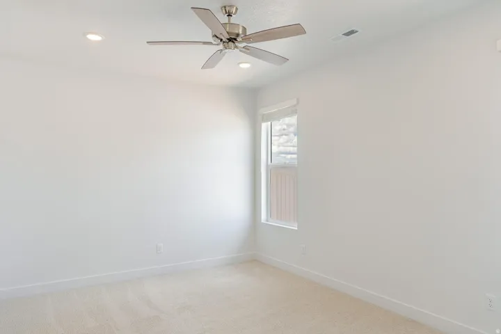 Recessed lighting, ceiling fan, single window, and neutral carpet