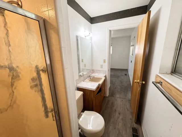 Bathroom featuring a vanity with a countertop, an integrated sink, and an overhead light fixture