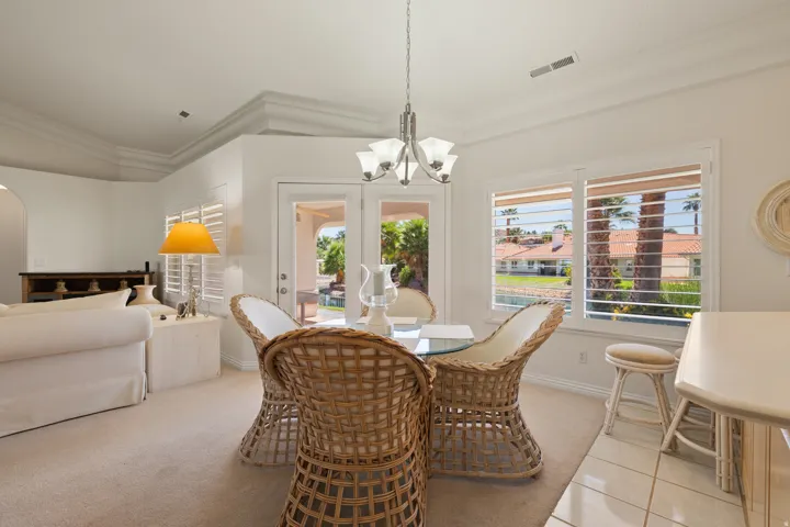 Crown molding, recessed lighting, plantation shutters, French doors, and tile flooring