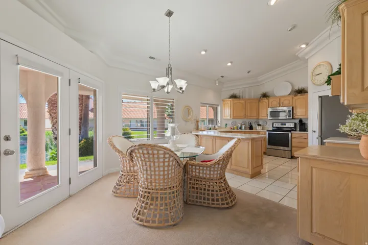 Gourmet kitchen featuring wood cabinetry, stainless steel appliances, and a central island with a breakfast bar