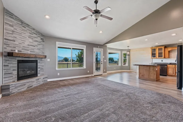 Vaulted ceiling with recessed lighting and a ceiling fan